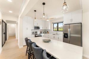 a kitchen with a large white island in a kitchen with a refrigerator at Mullins Bay View - 4 Bed - Sea View, Infinity Pool in Saint Peter