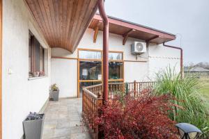 a porch of a house with a wooden awning at Easy Sleep - Comfy Stay in Soltvadkert +20 photos