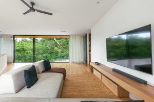 a living room with a large flat screen tv at Tenowi Villa in Mal País