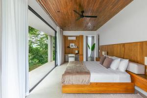 a bedroom with a bed with a wooden ceiling at Tenowi Villa in Mal País +46 photos