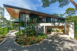 a modern house with a glass facade at Tenowi Villa in Mal País