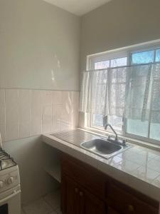 a kitchen with a sink and a window at 1Fusion2 in Negril +42 photos
