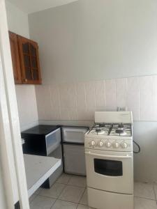 a kitchen with a white stove top oven in a kitchen at 1Fusion2 in Negril