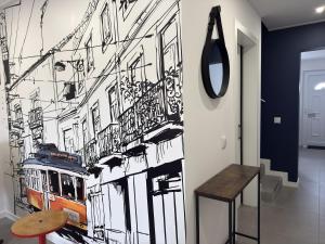 a wall mural of a city with a tram at Alma do Tejo - Alma Nossa in Montijo