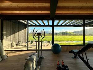 a gym with exercise equipment and a large window at Casa Anjana in Rubayo