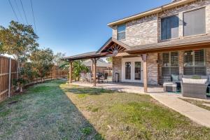 a house with a patio and a fence at 5Br Lux! Pool, Games & Theater in Rowlett