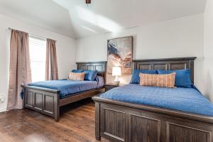 a bedroom with two beds and a window at 5Br Lux! Pool, Games & Theater in Rowlett +33 photos