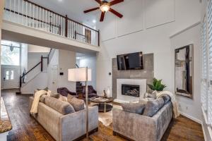 a living room with two couches and a fireplace at 5Br Lux! Pool, Games & Theater in Rowlett