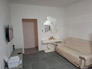 a small room with a bed and a tv at Le Chalet d'Ajoupa in LʼAjoupa-Bouillon
