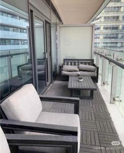 a balcony with couches and a table on a building at Pine Breeze in Markham