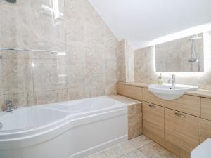 a bathroom with a tub and a sink at Win Hill View in Bamford +15 photos