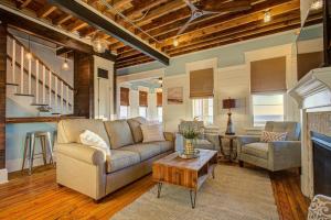 a living room with a couch and a table at 4115 - Coastal Cottage in Kitty Hawk +69 photos