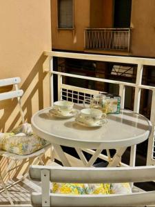 a white table with two cups and saucers on it at Casa di Ale in Rapallo