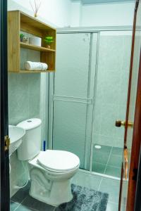 a bathroom with a toilet and a glass shower at Espacio Ideal 201 in Yopal