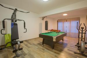 a room with a pool table and exercise equipment at Jezerska Villa in Ogulin