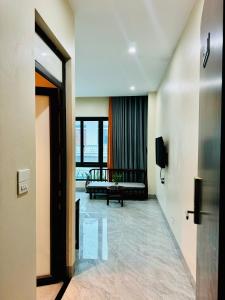 a hallway with a room with a couch and a window at An's Home Ninh Binh in Ninh Binh