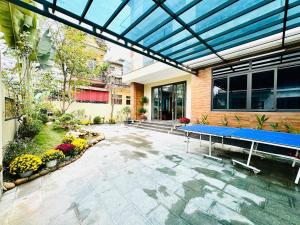 a patio with a blue table in front of a building at An's Home Ninh Binh in Ninh Binh