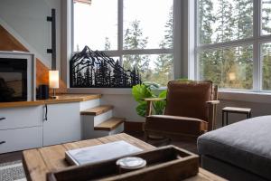 a living room with a couch and a chair at Fully Renovated Penthouse Loft at Fernie Alpine Resort in Fernie