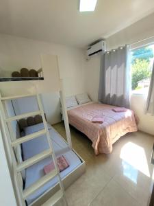 a bedroom with a bunk bed and a ladder at Apartamento com estacionamento in Uruguaiana