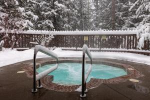 a swimming pool covered in snow in a yard at Fully Renovated Penthouse Loft at Fernie Alpine Resort in Fernie