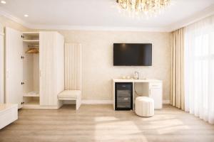 a living room with a tv on a wall at Yerevan In Boutique Hotel in Yerevan