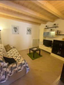 a living room with a couch and a table at Casa Vacanze La Romantica in Chiavenna