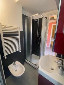 a bathroom with a sink and a shower and a toilet at Casa Vacanze La Romantica in Chiavenna +10 photos