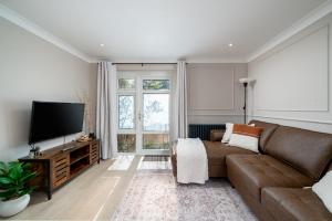a living room with a couch and a flat screen tv at 2 Bed Flat in Woking Central in Woking