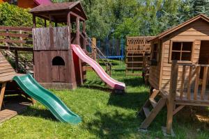 a playground with a slide and a play house at Agroturystyka ZIELONA ZAGRODA w Kosztowej in Dubiecko