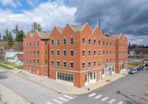 a large brick building on the corner of a street at Brewster Hall in Cheney