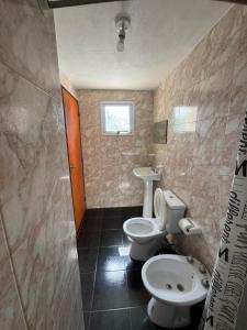 a bathroom with a toilet and a sink at Complejo El Teyu in Miramar