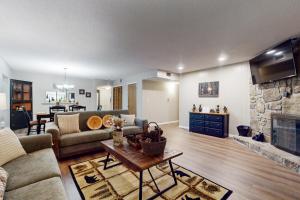 a living room with a couch and a fireplace at Charming Condo Sleeps 6 Shared Pool Gym Fireplace in Gatlinburg