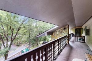 an image of a balcony with a large window at Charming Condo Sleeps 6 Shared Pool Gym Fireplace in Gatlinburg