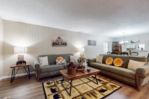 a living room with two couches and a table at Charming Condo Sleeps 6 Shared Pool Gym Fireplace in Gatlinburg +15 photos