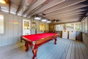 a room with a red pool table in it at Charming Mtn View Cabin Sleeps 8 Spacious Deck in Townsend