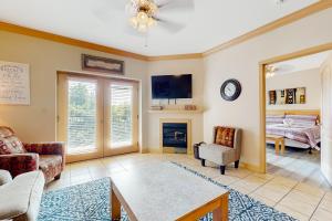 a living room with a couch and a fireplace at Charming Condo W Shared Pools Sleeps 6 Playground in Pigeon Forge