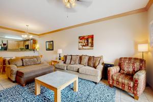 a living room with a couch and a chair at Charming Condo W Shared Pools Sleeps 6 Playground in Pigeon Forge +12 photos