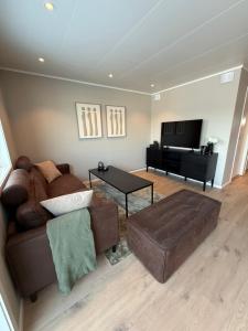 a living room with a couch and a piano at Experience Senja in Senja