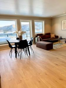 a living room with a table and chairs and a couch at Experience Senja in Senja