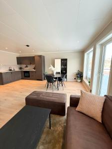 a large living room with a couch and a table at Experience Senja in Senja +7 photos