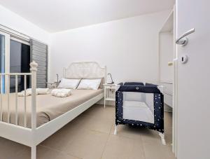 a bedroom with a white bed and a window at Appartamento Via Filatoio 9 in Domaso +9 photos