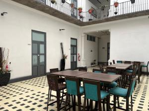 a dining room with wooden tables and chairs at Hotel Alhaja Puebla Centro Histórico in Puebla