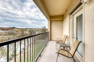 a balcony with two chairs and a window with a view at River View Condo Sleeps 6 Shared Hot Tub & Pool in Pigeon Forge