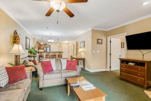 a living room with a couch and a tv at Downtown Summit Manor Sleeps 8 Mtn Views Pool in Gatlinburg