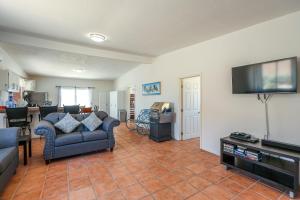 a living room with a couch and a flat screen tv at Casa Sonora in Puerto Peñasco