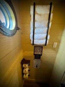a bathroom with a mirror and rolls of toilet paper at "The 19th Hole" Luxury Treehouse w Golf Views & Private 20ft Slide - 10 Miles from Dollywood in Sevierville +39 photos