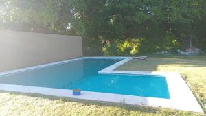 a small blue swimming pool in a yard at El encanto in Santa María