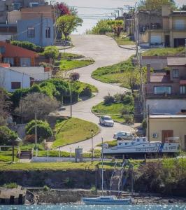 a boat parked in a parking lot next to a road at El Jacaranda in Carmen de Patagones