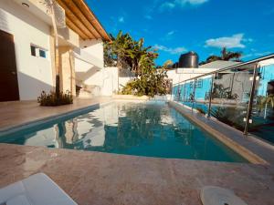 a swimming pool in front of a house at Villa Dylan Samana, Luxury 3Br with pool in Santa Bárbara de Samaná