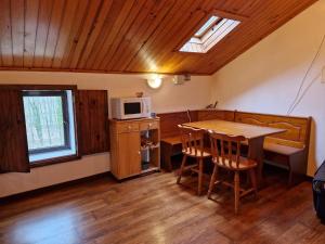 a small kitchen with a table and a microwave at Carneiro Country Houses Casa das Batatas in Amarante
